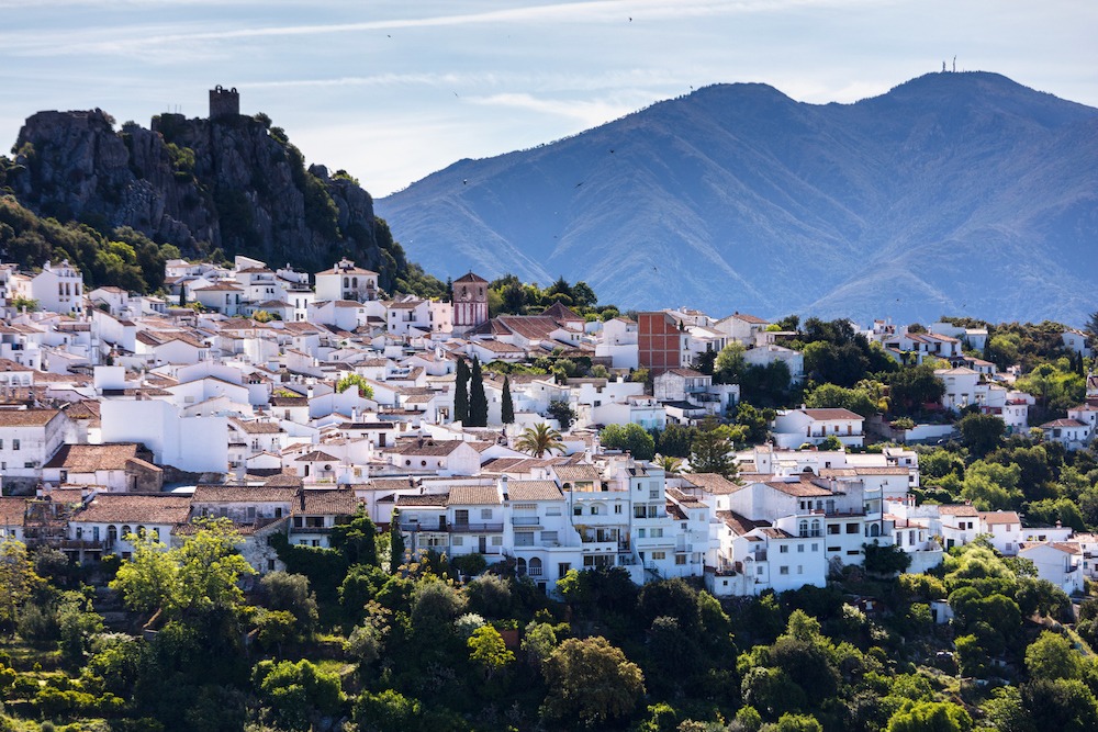 White spanish town with a mediaval castle on a hill